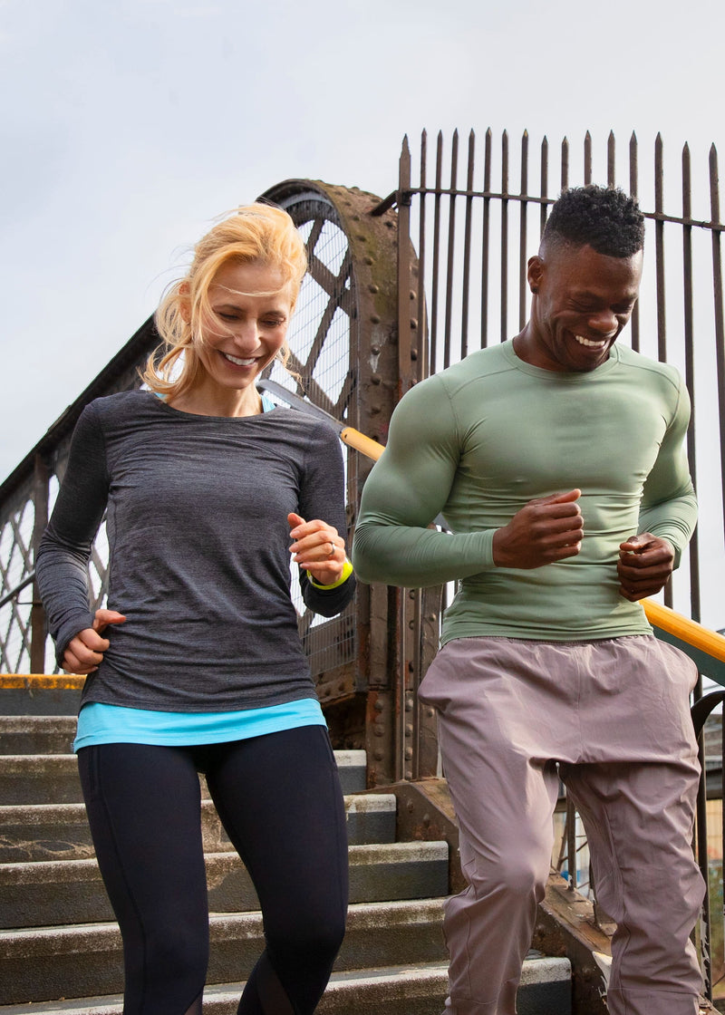 Two people running down some stairs outside whilst on a run